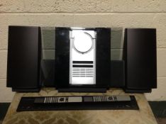 A Bang and Olufsen Beocentre 2300 with speakers (a/f) together with two Bang and Olufsen remotes.