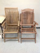 Two pairs of folding teak garden armchairs