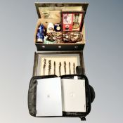 A box of ornaments, wooden carved masks, guitar montage, laptop in bag.