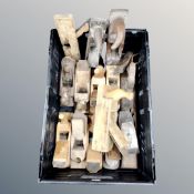 A crate containing vintage wooden woodworking planes.