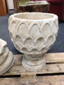 A concrete planter on stand