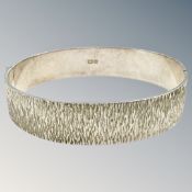 A textured silver bangle, diameter 6cm. CONDITION REPORT: 27.