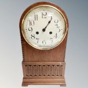 An Edwardian oak mantel clock.
