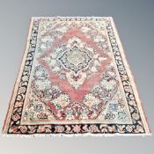 A Persian-design rug on red ground