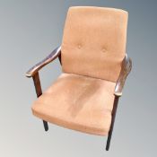 A 20th century armchair in rust coloured fabric