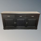 A contemporary oak triple door sideboard