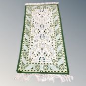 A North African fringed woolen rug of geometric design