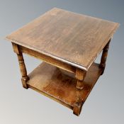 An oak two tier occasional table
