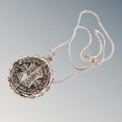 A 1945 half crown in silver mount on chain.