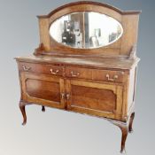An Edwardian oak Queen Anne style mirror backed sideboard