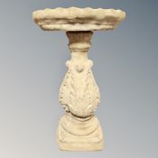 A concrete garden bird bath