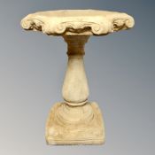 A concrete garden bird bath