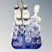 A tray containing assorted etched and cut glass drinking glasses, decanters,