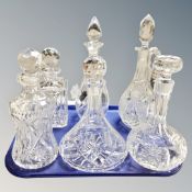 Six assorted cut glass decanters.