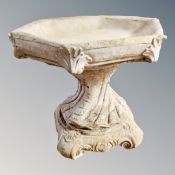 A hexagonal concrete garden bird bath on stand