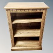 A contemporary Ercol bookcase in an oak finish