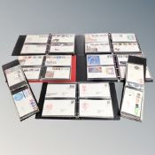 A basket containing seven albums of first day covers