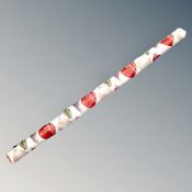 A roll of woodstock upholster's fabric, leaf patterned.