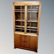 An Edwardian oak double door glazed bookcase
