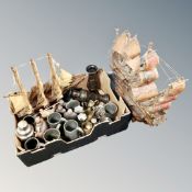 A box containing two wooden galleons, antique and later metal wares, hip flask, cruets set,