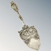 An ornate silver cake slice,
