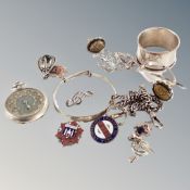 A bag containing miscellaneous jewellery, enameled badges, chain, napkin ring, pocket watch, etc.