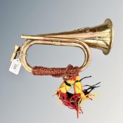 A copper and brass bugle with artillery badge and tassels