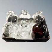 A box containing six demijohns.