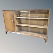 A mid century sliding glass double door bookcase on raised legs