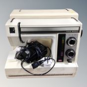 A New Home electric sewing machine in case.