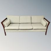 A late 20th century Scandinavian stained beech framed settee upholstered in a green striped fabric.