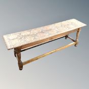 A carved oak Arts and Crafts stool,