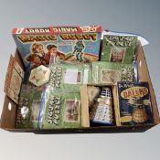 A box containing vintage interlocking puzzles, a Dr Who battery operated dalek box,