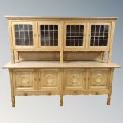 A Danish blonde oak four door leaded glass buffet back sideboard,