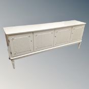 A 20th century Scandinavian four door sideboard on raised legs