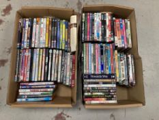 Two boxes of DVDs - approximately 100.