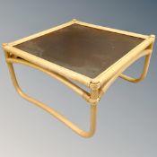A bamboo and wicker conservatory coffee table with frosted glass top.