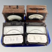 Four vintage volt metres.