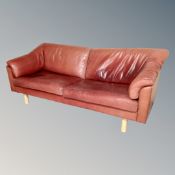 A late 20th century Scandinavian three-seater settee and two-seater settee upholstered in red