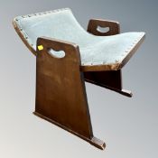 An Art Deco style vanity stool in studded turquoise fabric.