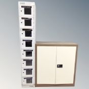 A metal double door stationary cabinet together with a further narrow metal eight door locker