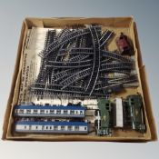 A box containing vintage rolling stock and track.