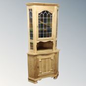 A Danish blonde oak leaded glass door corner cabinet, fitted cupboard beneath.