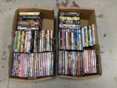 Two boxes of DVDs - approximately 100.