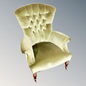 A Victorian style armchair in green dralon