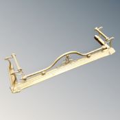 A brass Art Nouveau fire curb, external dimensions 140 cm x 40 cm, internally 122 cm x 30 cm.