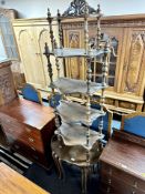 A nest of three 20th century pie crust edged tables together with a Victorian style five tier