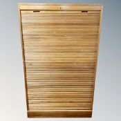 A 20th century oak shutter front office cabinet with key, height 145 cm x 89 width, depth 38.5 cm.