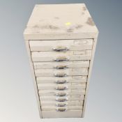 A metal ten drawer filing chest containing hand tools and hard ware