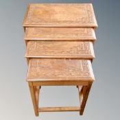 A nest of four carved walnut tables